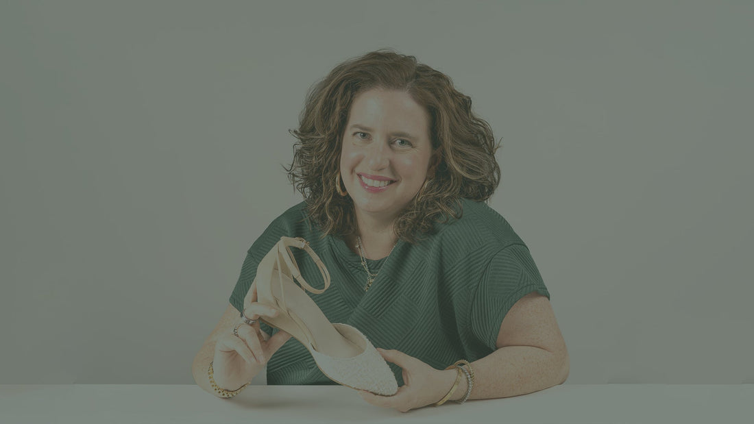 Dr. Steffie smiles while holding a Steffie’s heel, highlighting the RoamFoam™ cushioning technology featured in the “Walk Tall. Land Soft.” blog post